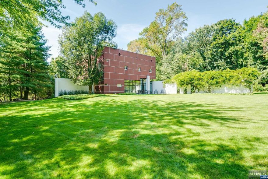 This magnificent house by UKZ Architects introduced Modernism to North Caldwell,19 miles from New York City. This one of a kind, award winning residence is a work of art. The home is comprised of two primary elements- two right angle L-shaped walls that intersect and provide context for the juxtaposition of inside and out. Nature is brought in with the L-shaped wall, beginning in the garden, adorned with a wisteria vine. Newly renovated Kitchen has Wolf Stove/Oven/ Microwave, Miele dishwasher, Subzero Refrigerator. Beautiful Master Suite with new Bath. Convenient to shopping, restaurants, museums, libraries, theatres, Montclair, train, bus to NY. Experience living in modern art!