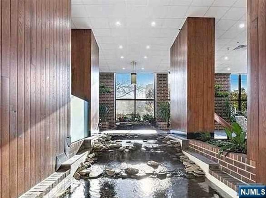 Enjoy stunning panoramic views of NYC and the Hudson River from this spacious south-east facing one-bedroom home! With 1,122 sq. ft., this is the largest one-bedroom layout available and features an open-concept living area, granite countertops, updated kitchen appliances, and beautiful hardwood floors. The generous master suite includes a full bathroom and a large walk-in closet. A convenient half-bath is located off the living room for guests. This luxury building offers top-tier amenities including a doorman, 24-hour security, pool, sauna, Gym, and one indoor parking space. Located with direct NYC bus service in front of the building, and just minutes from great restaurants and shopping. You Must see!!