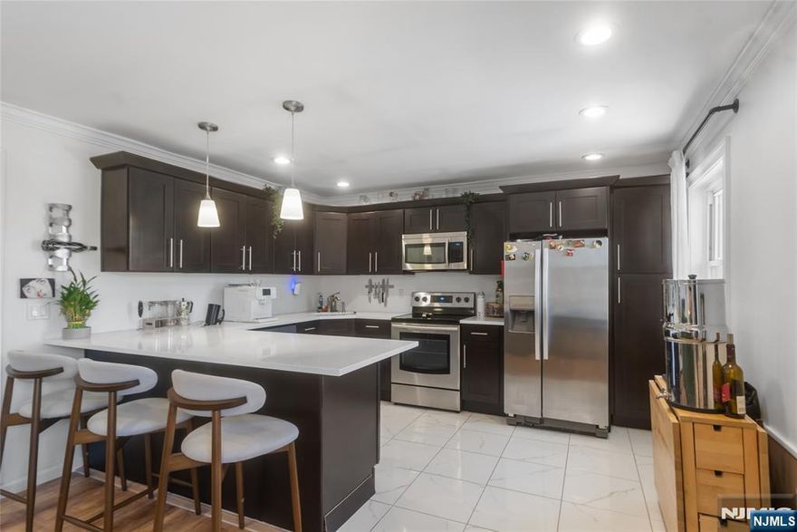 Welcome to this beautifully updated 2-bedroom condo with modern finishes and an unbeatable location. Hardwood floors throughout, recessed lighting, and a sleek, contemporary design. The kitchen features quartz countertops, stainless steel appliances, custom cabinetry, and opens to a bright living/dining area. Spacious bedrooms, primary with his-and-hers closets. Updated full bath. Parking included. Steps to NYC transportation, parks, schools, restaurants, and shopping. This wonâ€™t last!