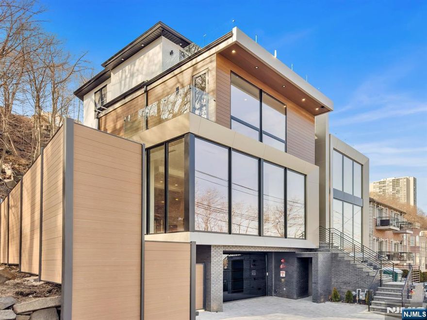 Discover luxury living at 582 Undercliff Avenue in Edgewater. This newly constructed home offers four levels of luxurious living across nearly 5,200 sq. ft. With 5 bedrooms and 5.5 bathrooms, its open-plan design seamlessly flows from the Veneta Cucine kitchen to the gorgeous dining and living areas, all framed by floor-to-ceiling windows showcasing NYC views. Luxury is in every detailâ€”13-foot ceilings create an airy ambiance, while spa-inspired en-suite bathrooms offer a private retreat. The lower level features a spacious recreation room with, a full bath, and an indulgent sauna. Exquisite craftsmanship is evident in Adriani e Rossi wall panels, Dekton countertops, and a butler's station with a wine library. Thoughtful touches like custom lighting, a striking Italian gas fireplace, and a top-floor kitchenette enhance the living experience. Additionally, the property's left side borders the serene Palisades Park Recreation Area, a secluded green space. 5 minute walk to the ferry to NYC, plus Whole Foods and delicious Edgewater restaurants. Don't miss the sophistication and comfort.