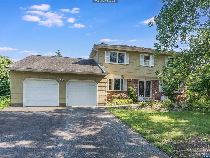 This Center Hall Colonial is perfectly located on a quiet cul-de-sac in one of the most desirable sections of Wayne! This home features 4 Bedrooms and 2.5 bathrooms. Double front doors lead you into the main hallway with spacious living room on one side and dining room on the other. Large and bright eat-in kitchen is located at the end of the hallway, overlooking landscaped private backyard. The Family room with vaulted ceiling and fireplace is located off the kitchen, sliding doors exiting onto the paved patio. Powder room and garage access complete first floor. Second floor features primary bedroom en-suite, additional 3 bedrooms and full bathroom. Ample closet space, wooded floors throughout, Pella windows. A fully finished basement offers plenty of additional space for a playroom, office or gym. Laundry room, workspace and a utility room completes this floor. Attached a 2-car garage with spacious blacktop driveway. In close proximity to NYC transportation,schools and shopping.