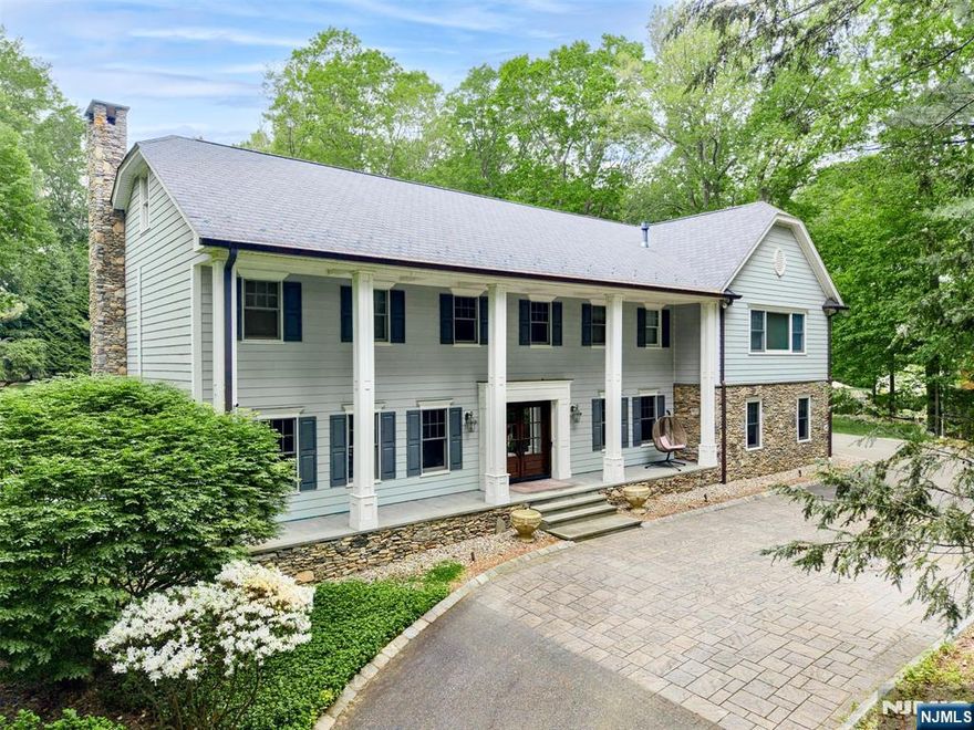 Experience the perfect blend of classic design and modern comfort in this bespoke center hall colonial, set on over 2 acres with a backyard oasis. Enter into a grand foyer with heated marble flooring, flanked by a banquet-sized dining room and elegant living room. At the heart of the home is a modern eat-in kitchen with high-end Dacor appliances that seamlessly connects to a family room with built-ins and a fireplace. Wrapping up the 1st level is a convenient bedroom and renovated full bath. Upstairs, you'll find 4 bedrooms and a flex/bonus area, including a primary suite with a tray ceiling, fireplace, walk-in closet, and a luxurious full bath with radiant heated floors. Expansive basement includes a rec room, dry bar, and designated gym room. The backyard is an entertainer's paradise, with a heated gunite pool, koi pond, fire pit, and sound system. Additional amenities include a whole home generator, an attached heated garage, and smart home features. A must see!