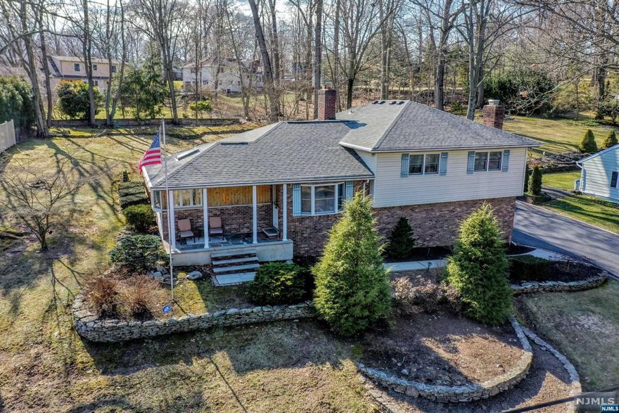 This beautiful expanded split-level is set far back on the property, providing privacy & tranquility in a super location. As you enter the home, you'll be greeted by a bright & spacious living room, featuring custom built-ins, granite gas fireplace, the vaulted ceilings & skylights. The EI kitchen features wood cabinets and new appliances. The formal dining room w/ sliding doors to the ample deck for outdoor entertaining overlooking the private backyard. Detached 2 1/2 car garage w/ storage attic, large driveway for extra parking. Upstairs, private en-suite w/ dressing area. Two additional bedrooms and full bath. Finished lower level offers LR, one bedroom, full bath & game room w/ sliding door w/ private access to backyard, perfect mother/daughter suite. 3 zone heat/AC, new roof (2022), hardwood floors & undergrounded sprinkler. Don't miss out on this wonderful home!