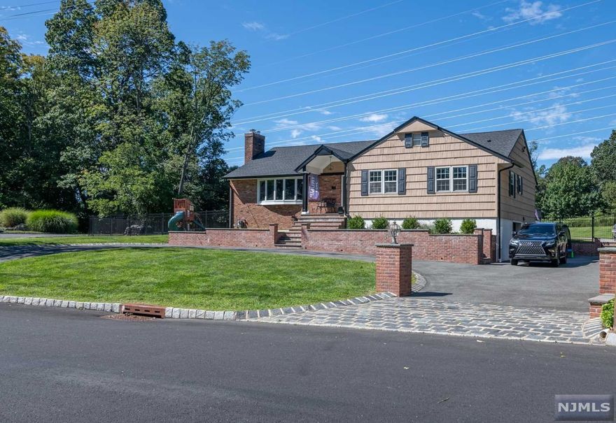 You have to see this beautiful property, single floor living at its best! Featuring spacious yard, circular driveway, and many updates throughout. Completely fenced in backyard, bluestone patios in both the front and rear, cedar siding, and an approx. 600 sqft deck accessible from the oversized bright family room. Some updates include new roof, brickwork, sewer and water lines, and fully paved driveway with cobblestone inlays. Amazing kitchen w/tons of storage, hardwood floors, steam shower in the ensuite, plus a walk-in closet. Full finished basement with laundry room, rec area, utilities, and walkout to the garage.