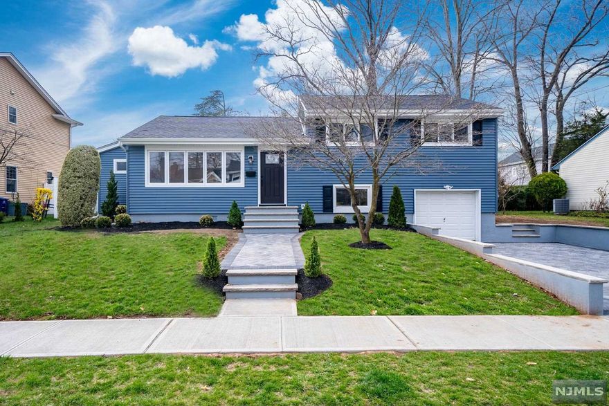 Marvel at this completely renovated split-level home in Dumont! The curb appeal on this property is where it all begins, with a stunning paver driveway and main entrance walkway. The open concept living room and kitchen is beautifully bright with tons of natural lighting. With stainless steel appliances and sink, they are the perfect touch to this striking design. The primary bedroom located on the main floor has two very spacious closets and a spectacular bathroom equipped with a double sink vanity and large shower. Upstairs you have 3 additional bedrooms and a beautiful full bath. Ground level is a great additional space with a full bath, laundry, and access to the garage. The backyard opens with a large deck and beautiful landscaping. Plenty of space for outdoor enjoyment!