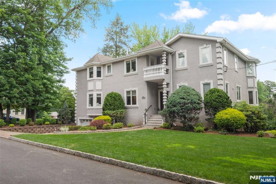 Located on a quiet street, this well-maintained custom colonial offers approximately 3,700 square feet of living space with thoughtful details throughout. A standout feature is the circular staircase surrounded by windows, creating a bright and open feel. The home also includes custom moldings, hardwood floors, and five balconies off the family room, dining room, primary bedroom, and two additional bedrooms. This home also comes with a convenient central vacuum system. The first floor features a two-story entry with marble floors, a living room with cove lighting and double sided gas fireplace, a large family room with a bay window and balcony, a spacious kitchen with center island, and a formal dining room with access to a balcony. Upstairs, the primary bedroom includes a private balcony and a renovated bathroom. Three additional bedrooms and two updated full bathrooms complete the second floor. The ground level offers a flexible space that includes a home office, storage, and a bright entertainment room with 14-foot ceilings, new carpeting, and sliding doors to a private patio and access to the unique private yard in 3 levels!