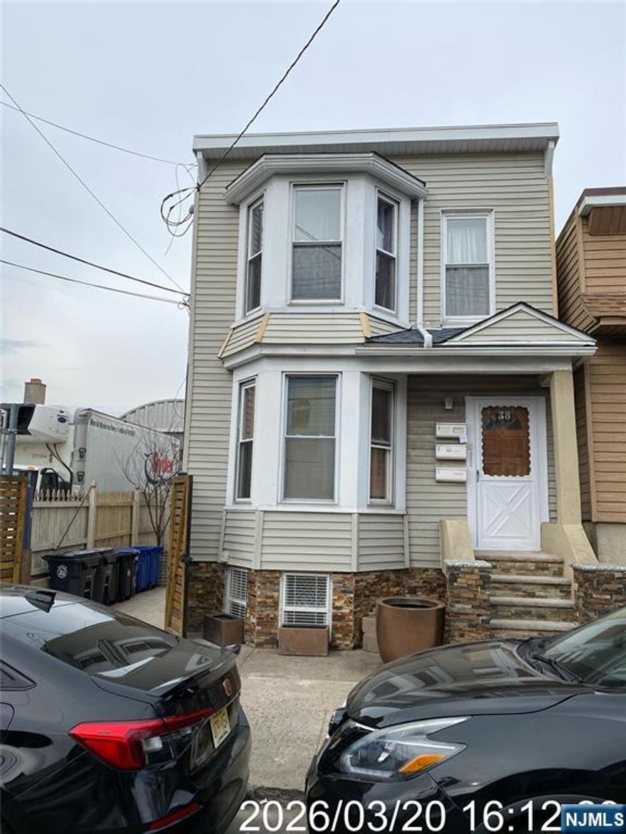 Investment opportunity in a prime Ironbound location. Sold "As Is. Unique layout offers a front multi-family plus a separate rear single-family perfect for maximizing income, flexibility, and long-term value. Front Unit 1 (1st floor + lower level) lives like an expanded residence: 1 bedroom, living room, eat-in kitchen, full bath, plus 4 additional bedrooms and a second full bath below: Central A/C, forced-air heat, updated water heaters, and laundry hookup (tenant-owned). Unit 2 (2nd floor) features 2 bedrooms, an eat-in kitchen, a full bath, laminate/ceramic flooring, gas heat, window A/C, updated plumbing, and a newer water heater. Tenant pays electric and 40% gas. The rear home is ideal for owner-occupancy or premium rent: open-concept living, half bath, and modern kitchen with stainless steel appliances. The second floor offers 2 bedrooms, skylights, and a full bath. Hardwood floors, central A/C/heat, and tankless water heater. Covered outdoor area adds lifestyle appeal. Additional highlights include a fenced yard with gated access and a storage shed. Walk to Newark Penn Station (NYC-25 min), near major highways, Newark Airport, top dining, shopping, and a fast-growing business district.