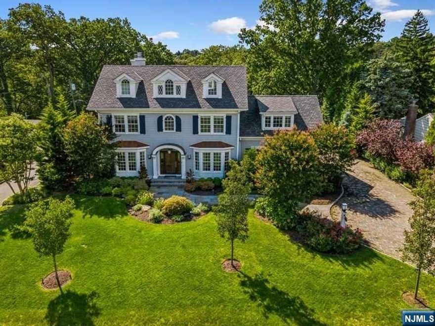 Exquisite Colonial sits atop of 11-acre picturesque Yantacaw Brook Park offering one of a kind panoramic views. Home is breathtakingly beautiful & elegant offering soaring ceiling, stunning millwork & abundance of natural light. Formal rooms include LR with wood burning fireplace & custom shelving, DR & formal powder. FR with another wood burning fireplace, sunrm & kitchen all have radiant heat & stunning panoramic views of park. Chef inspired kitchen is loaded with special features including top of the line cabinetry & appliances, coffee bar & butler's pantry equipped with 250-bottle wine cooler. Stunning Primary Suite boasts vaulted ceiling, gas fireplace, custom closets, lux marble bath & ext. deck. 3 add'l BRs, 2 with ensuites, hall BA, den & laundry complete 2nd level. Expansive 3rd flr BR suite has full bath. LL offers huge media/game rm, spectacular gym, full BA, BR & plenty of storage. Lush backyard has great views of the park. Finished 2-car garage with epoxy floor.