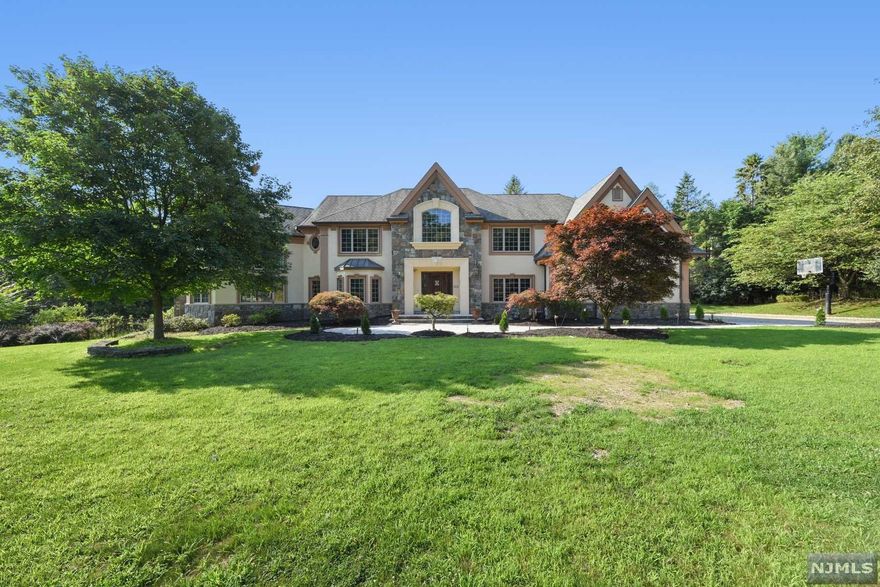 This luxurious custom-built home welcomes you with an impressive two-story foyer and library. Beautiful great room features custom molding, fireplace and wet bar. Modern custom kitchen commercial range, wine fridge, huge walk in pantry, and eating area. Spacious master suite has 2 large walk-in closets, Dress room, Jacuzzi tub and shower. All 6 bedrooms have custom-built closets. Finished walk out basement includes playroom, wine cellar/card room, office and full bath. House also features limestone walkways, large deck, security cameras w/night vision and wired speakers throughout the house. Nice four car garage. Pool plans are available to buyer.