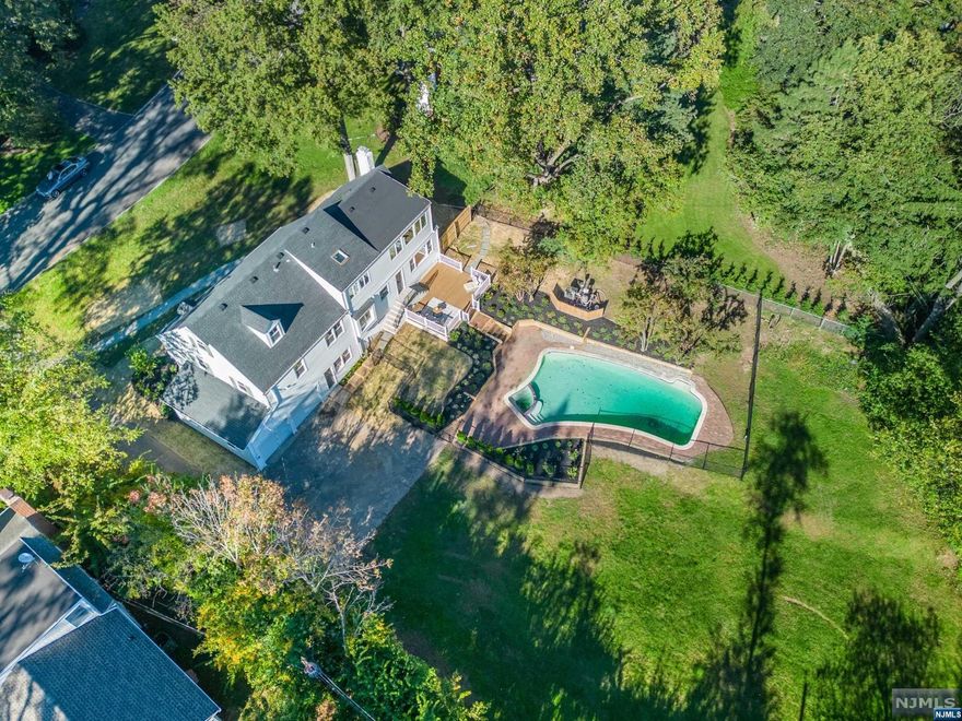 STUNNING COMPLETELY RENOVATED 6-BEDROOM COL ON HUGE LOT W/POOL. CLOSE TO NYC DIRECT TRAIN. Gorgeous state of the art kitchen w/ Bertazzoni 6-burner stove, Bertazzoni double-doored paneled fridge. Bosch dw, huge quartz center island w/pendant lighting & gold accents, plenty of cabinetry incl pantry & tons of windows! Approx 1/2 acre flat bkyrd w/pool & plenty of space for entertainment. Showpiece living room has floor to ceiling built-ins & wb fireplace. 2nd flr boasts four bedrooms + newly renovated main bath. Gracious, sunfilled primary bdrm on 3rd lvl includes skylight, sitting area overlooking bkyrd & pool. Freestanding egg-shaped soaking tub, double sinks, skylight, glass-doored shower, elegant floor tiles & fixtures. Lwr level is perfect fam rm + there's a convenient full bath attached. MORE room in fully fin bsmt...can be playroom, pool room, guest room, endless possibilities. Gas heat, AC, HW flrs, 2-car garage. Enjoy 3 parks all less than a 1/2 mile away.