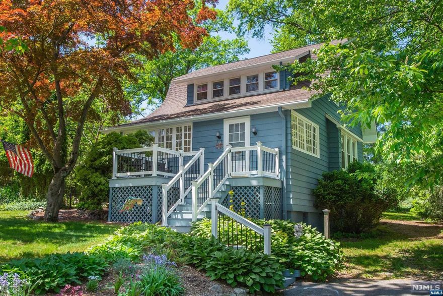 Beautiful move in ready home set on expansive, private, park like property with patio, gardens and ponds. Gorgeous hardwood floors throughout, a beautifully renovated eat in kitchen with new white shaker cabinets, granite counters, SS appliances, and farm sink. A stunning stone fireplace with gas stove insert adds warmth and coziness to the charming living room. Each floor has one renovated full bath with newer vanities that have marble countertops. The bedrooms are spacious and offer ample natural light. The entire exterior has been repainted a beautiful warm blue, with white trim. Gorgeous columns, window seats, large windows and plenty of light add character and warmth to the space. Beautiful front porch with original historic windows. Lots of storage. Incredible, convenient location, walk to town and trains yet completely private. High and dry. Detached garage with driveway, central air, partially finished basement. Not in a flood zone, dead end st. Nothing to do but move in