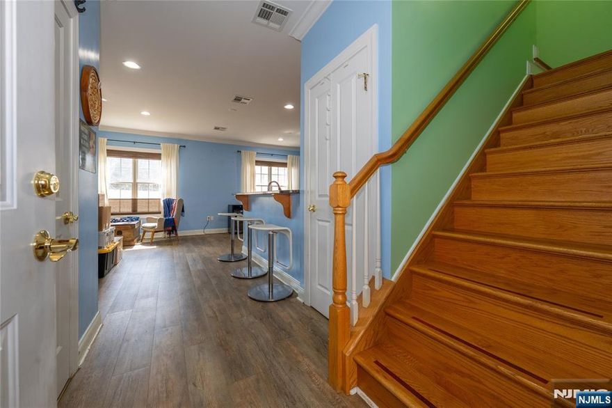 Welcome to one of Bayonneâ€™s most impeccably maintained condominiums, proudly offered by its original owner who has cared for every detail with exceptional pride. This stunning multi-level home is filled with abundant natural light throughout, creating a warm and inviting atmosphere from the moment you enter. The ground level features a sun-filled open layout with a spacious living room, dining area, and modern kitchenâ€”perfect for both everyday living and entertaining. The kitchen is equipped with granite countertops, a breakfast bar, and high-end stainless steel appliances, offering both style and function. A full bathroom and oversized pantry add convenience and valuable storage to this level. On the second floor, retreat to the expansive primary suite complete with a massive walk-in closet and a spa-like ensuite bath featuring a double vanity, a luxurious soaking tub for two, and a separate enclosed shower. A second generously sized bedroom with its own full bathroom sits just across the hall, providing comfort and privacy for guests or family members. The top level is truly specialâ€”an airy, light-filled loft that serves as the ultimate entertaining space, home office, or lounge. Step outside to a large private balcony with unobstructed southern Bayonne views, perfect for relaxing evenings or hosting gatherings. This floor also includes a convenient half bath and laundry room. Rounding out this exceptional home are two off-street parking spaces, a rare and highly desi
