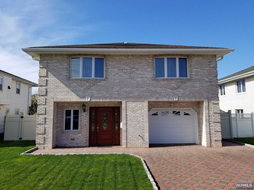 WOW! DO NOTHING, SIMPLY MOVE IN! THIS BRIGHT & SPACIOUS HOME LOCATED JUST A 6-MINUTE WALKING DISTANCE FROM NYC BUS STOP (#160) SHOWS PRIDE OF OWNERSHIP! THE 1ST FLOOR WELCOMES W/LG LR, DR, MEIK W/GRANITE COUNTERTOPS, MBR W/ 0.5 BATH, 2 GOOD SIZED BRMS & MAIN BATH(SOT) W/SKYLIGHT. PLENTY OF CLOSETS & AN ABUNDANCE OF NEWER ANDERSEN WINDOWS ALLOWING SUNLIGHT TO SHINE THROUGH. BEAUTIFUL HARDWOOD & CERAMIC TILE FLOORS. THE GROUND FLOOR OFFERS ENTRANCE FOYER W/LG CLOSETS, HUGE FAMILY RM, LG BRM, FBTH, & SUMMER KIT W/GRANITE COUNTERTOPS & SLIDERS LEADING TO A COVERED PATIO & NICELY MAINTAINED BACKYARD, FENCED FOR PRIVACY. THE GROUND FLOOR COULD EASILY BE USED AS A GUEST OR IN-LAWS SUITE. 1-CAR ATTACHED GARAGE & LG 2 CAR DRIVEWAY. PAVERS IN DRIVEWAY, PATIO, WALKWAYS & ALL BRICK EXTERIOR. MANY UDATES INCLUDING NEWER FRONT DOOR, INTERIOR DOORS, MOULDINGS, MAIN KITCHEN W/SS APPLIANCES, BATHROOMS & MORE. 2-ZONE GAS HEAT & C/A/C. EASY ACCESS TO NYC. THIS HOME MUST BE SEEN. YOU WILL BE AMAZED!