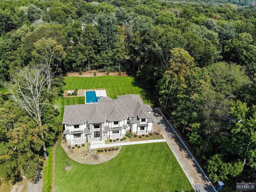 THE EPITOME OF ELEGANCE AND LUXURY IN SOUGHT AFTER DEMAREST - LOCATED MINUTES FROM NYC IN A TOP SCHOOL DISTRICT LIES YOUR DREAM ESTATE ON NEARLY AN ACRE. NO DETAIL IS SPARED IN THIS MODERN MARVEL WHICH BOASTS A 3 CAR HEATED GARAGE, 10 FOOT CEILINGS, AND 9,000 SQ FT OF LIVABLE SPACE INCLUDING THE FINISHED BASEMENT. JAW DROPPING ENTRY FOYER RUNS THROUGH THE CENTER OF THE HOME, WITH A 22 FT CEILING AND VIEWS STRAIGHT THROUGH TO THE BACK PATIO WITH OUTDOOR KITCHEN, FIREPLACE AND CUSTOM POOL W/SPA-JACUZZI THAT WILL SERVE AS YOUR PERSONAL OASIS. CUSTOM TRIM MOLDINGS AND PANELING, THE PARAGON OF TASTE. BREATHTAKING PRIMARY SUITE WITH TRAY CEILING, DUAL BOUTIQUE CLOSETS IN MAPLE, PRIVATE TERRACE AND ENORMOUS ENSUITE BATH WITH THE MASERATI OF SHOWERS. 9 ZONE RADIANT HEAT, SMART HOME FEATURES, GOURMET KITCHEN IN QUARTZ WITH WOLF AND SUB-ZERO APPLIANCES, 2 LAUNDRY ROOMS. BUILT IN 2020 AS TRUE NEW CONSTRUCTION, WITH NEW FOUNDATION & 10 YEAR WARRANTY