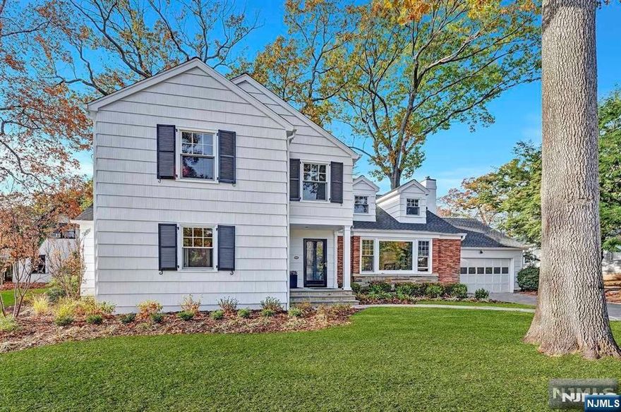 Situated on one of the most desirable streets in town, this renovated and expanded Colonial offers a unique opportunity for refined living. With over 4,200 square feet of luxurious space, this home seamlessly blends classic charm with modern amenities.Upon entering, you're greeted by the warmth of hardwood floors that flow throughout the house. The expansive layout features a gourmet kitchen, perfect for culinary enthusiasts, with top-of-the-line appliances and ample counter space. Adjacent to the kitchen, a charming breakfast room invites casual meals bathed in natural light.The home boasts five spacious bedrooms and four full baths, along with two half baths. The first-floor en suite bedroom is ideal for guests or multi-generational living. The second floor reveals another en suite bedroom and a luxurious master suite, a private retreat with a large en suite bath and a versatile bonus room, perfect for an office or sitting area.Practicality meets style with a second-floor laundr