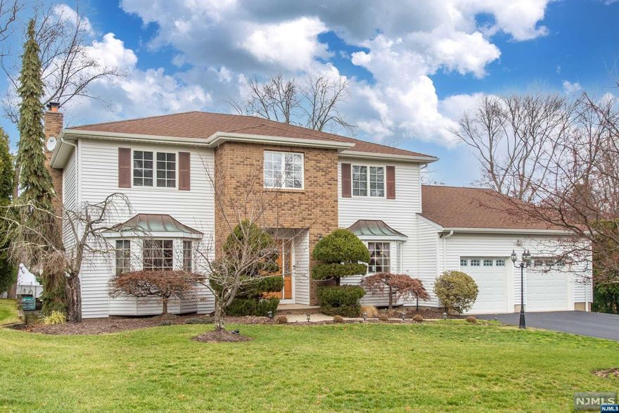 LOCATION! LOCATION! LOCATION! This well kept Center Hall Colonial is located on one of the nicest streets in Wayne Township! Tall Grass Drive is a double Cul-de-sac offering privacy & safety. This home offers a large composite deck off the kitchen - great for entertaining - 4 spacious Bedrooms - 3 updated baths. Hardwood flooring throughout! New tankless 4 zone baseboard heating & hot water system. Updated Central Air system, whole house general generator, updated leiters & gutters. French drain w/new sump pump. Central Vac system in "as is" condition. Conveniently located near restaurants, shopping, schools, houses of worship, & NJ Transit.