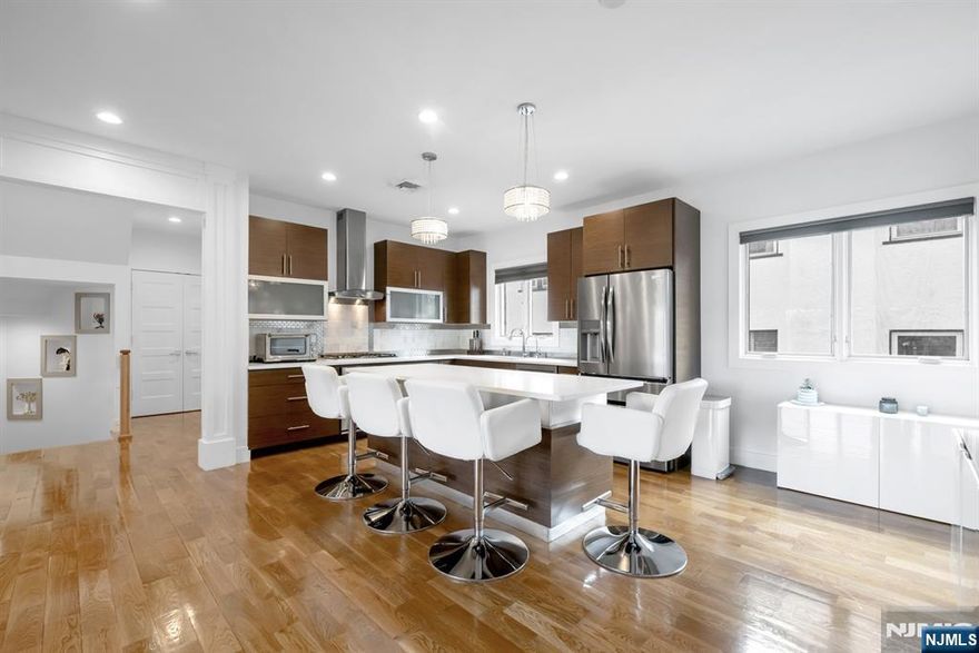 Welcome home to this stunning, meticulously well kept 3 Bedroom / 2 Full & 2 Half Bathroom townhouse conveniently located in highly sought after Fort Lee. Stretching across four levels, this luxurious home features only the finest finishes with gleaming hardwood floors, recessed lighting, ample storage space, multi-zone heating and cooling, custom window treatments, CAT5 wiring throughout, snow melt system at front entrance, and a private backyard. First floor features a welcoming entry foyer, family room w/ built-in Murphy bed, half bathroom, utility room, storage space, and heated one car garage perfect for everyday living. Main living space on the second level includes an open concept living room w/ gas fireplace, Chef's kitchen, dining room, half bathroom, and laundry. Chef's kitchen features SS appliances, quartz countertops, custom cabinets, and center island w/ wine fridge. Third floor features a spacious Master bedroom with spa-like ensuite bathroom and custom walk-in closet, two guest bedrooms, and full bathroom. Completing this gorgeous home is a fourth level with office / nook, storage, and rooftop terrace perfect for entertaining. Conveniently located near award winning schools, plenty of shopping and restaurants, parks, and public transportation, this is truly a home you do not want to miss!