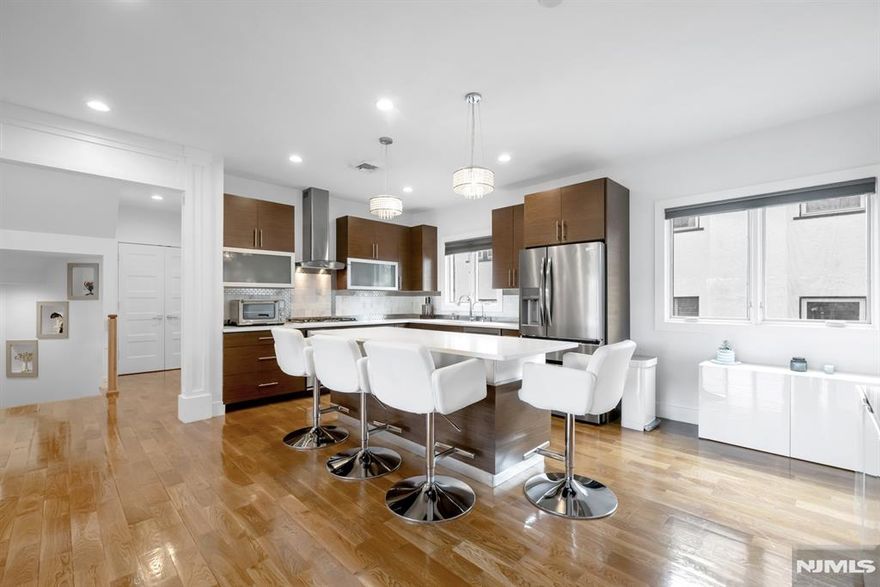 Welcome home to this stunning, meticulously well kept 3 Bedroom / 2 Full & 2 Half Bathroom townhouse conveniently located in highly sought after Fort Lee. Stretching across four levels, this luxurious home features only the finest finishes with gleaming hardwood floors, recessed lighting, ample storage space, multi-zone heating and cooling, custom window treatments, CAT5 wiring throughout, snow melt system at front entrance, and a private backyard. First floor features a welcoming entry foyer, family room w/ built-in Murphy bed, half bathroom, utility room, storage space, and heated one car garage perfect for everyday living. Main living space on the second level includes an open concept living room w/ gas fireplace, Chef's kitchen, dining room, half bathroom, and laundry. Chef's kitchen features SS appliances, quartz countertops, custom cabinets, and center island w/ wine fridge. Third floor features a spacious Master bedroom with spa-like ensuite bathroom and custom walk-in closet, two guest bedrooms, and full bathroom. Completing this gorgeous home is a fourth level with office / nook, storage, and rooftop terrace perfect for entertaining. Conveniently located near award winning schools, plenty of shopping and restaurants, parks, and public transportation, this is truly a home you do not want to miss!