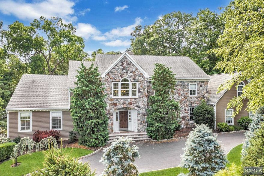 Cool, calm & sophisticated, this home is enveloped in light & comfort. Neutral walls, rich wood floors & high ceilings create a timeless style. Imagine entertaining friends & family in this gorgeous gourmet kitchen w/massive island or the adjacent stylish formal DR. Step into the comfortable Great room w/stone fireplace & access to multiple decks. The living room is a great place to cozy up by the fire or shoot pool. Immerse yourself in the spacious 1st floor Primary ensuite w/sitting room, WICs & luxurious bathroom. The 2nd floor is spacious with so much flexible space 2 ensuite BRs, BR, Full hall bath, Office/BR & large bonus room. The impressive lower level features a family room w/fplc, office, Gym, BR, full bath, cedar closet & storage. Step thru the sliders which open onto a gorgeous patio, fabulous heated pool & beautifully manicured private green space. Circular driveway & full house generator as well!. This house truly has it all nestled in an idyllic setting!
