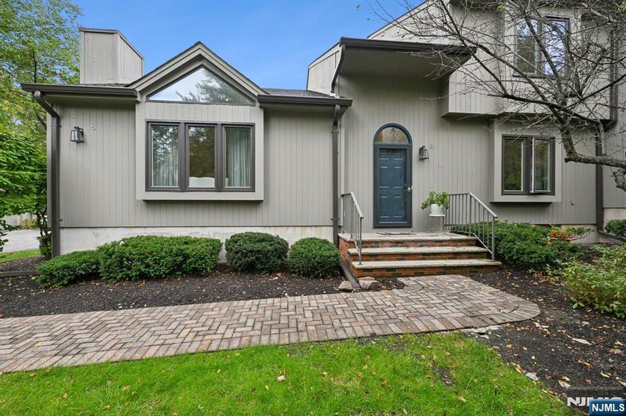 Don't miss this Rare Opportunity! Impeccably maintained, freshly painted, move-in-ready luxury end-unit townhome - the largest model in the Spruce Edge community! Experience a main level filled with natural light, featuring soaring vaulted ceilings, updated windows, skylights, and beautiful hardwood floors. The updated eat-in kitchen offers new cabinets, a new range/oven/microwave, and elegant LED lighting. The main level offers multiple gathering spaces: a formal dining room, a living room with a fireplace, a family room with a charming stone fireplace, and a sun-drenched den with sliders opening to a private deck overlooking a serene pond. Upstairs, the primary suite is a true sanctuary with an updated en-suite bathroom and two spacious walk-in closets. The two additional bedrooms each feature their own walk-in closet. The attached 2-car garage features an epoxy floor and a high-voltage plug, perfect for EV charging. A versatile finished basement includes a recreation room, laundry facilities, a cedar closet, and stylish tile flooring. Set on beautiful, park-like grounds, this prime location offers lake and beach privileges. Don't miss the opportunity to own this perfect blend of luxury and convenience.