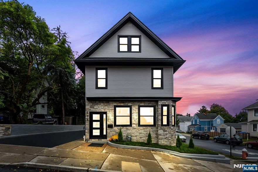 Welcome to 573 Anderson Avenue, Wood-Ridge, where modern design meets skyline views of New York City. This fully rebuilt 5-bedroom, 3.5-bath residence perfectly blends luxury, light, and livability. The open-concept main level invites you in with an elegant flow between the living, dining, and kitchen areas, framed by oversized Andersen windows that flood the home with natural light. At its center, a striking 8-foot island anchors the chefâ€™s kitchen, featuring a full-height designer backsplash, quartz counters, and premium stainless appliances - the ideal space for both gatherings and everyday living. A dedicated office on the main floor adds comfort and function. The second floor offers three spacious bedrooms, including a serene primary suite with a spa-inspired bath and walk-in closet. A second full bathroom completes this level with sophisticated tilework and stone finishes. The third floor expands the home with two additional bedrooms and another full bath, both enhanced by skylights and sweeping views of the Manhattan skyline. Downstairs, the finished basement provides a flexible area ideal for a gym, play room, or media room. Outside, enjoy the private corner lot with an above-ground pool, detached garage, and parking for four.