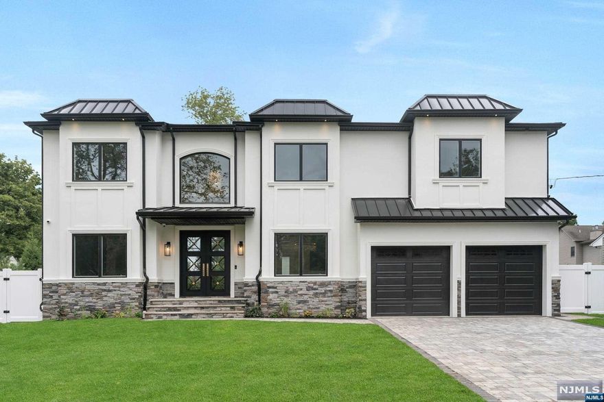 NEW CONSTRUCTION MASTERPIECE LOCATED ON THE ULTRA-DESIRABLE EAST SIDE FEATURING APPRX. 6,500 SQ FT OF FINISHED SPACE. MODERN WHITE STUCCO & STONE, METAL ROOF ACCENTS, & DOUBLE IRON DOORS PROVIDE PERFECT CURB APPEAL. STUNNING 2 STORY ENTRY FOYER W/HEATED FLOORS LEADS TO LR & FDR W/CUSTOM TRIMWORK & WALLPAPER. BUTLER'S PANTRY TO DREAM KITCHEN W/LARGE ISLAND, PROFESSIONAL APPLIANCES, PANTRY, BREAKFAST AREA, & WET BAR. STATELY 2 STORY FAM ROOM W/FRPL & CUSTOM TRIMWORK. ELEGANT POWDER ROOM, BED, FULL BATH, & MUDROOM COMPLETE 1ST FL. 2ND FL FEATURES A SLEEK PRIMARY SUITE W/2 CUSTOM WICS & SPA BATH W/LARGE WALK-IN SHOWER, SOAKING TUB, & HEATED FLS. JR SUITE W/FULL BATH, 2 MORE BEDS, FULL BATH, & LAUNDRY COMPLETE 2ND FL. FINISHED BASEMENT W/HOME THEATER, GYM, REC ROOM W/WET BAR, BED, & FULL BATH. STUNNING WIDE PLANK WHITE OAK FLOORING THROUGHOUT. 9 FT CEILINGS ON ALL FLOORS, SECURITY CAMERAS, SPEAKERS, CENTRAL VAC, SPRINKLERS, & FENCED YARD. CLOSE TO SCHOOLS, PARKS, SHOPPING, & NYC TRANS.