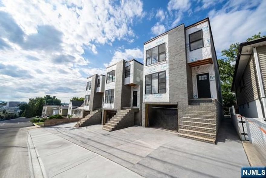 ..Stunning new construction residence boasts 3 bedrooms and 3.5 baths. The first floor features a spacious living room, dining room, well-equipped kitchen, and powder room. The second floor offers a luxurious master bedroom with a grand master bathroom, a walk-in closet, and two additional bedrooms with a full bath. The walk-out finished basement boasts a full bath as well. Act now to customize the finishes to your personal taste. Enjoy the unbeatable convenience of this prime location, situated near NY transportation, GWB, shopping, and schools. Traveling to the city is a breeze with bus or shuttle access to the ferry