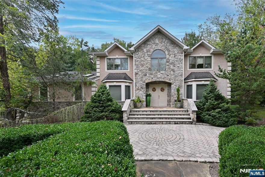 Welcome to this Stunning Colonial, blending luxury and exceptional amenities with natural beauty. Set on over an acre of lush, mature landscaping, this property is designed for both relaxation and entertaining. At its heart, a magnificent pool with built-in spa and waterfall feature is surrounded by an expansive Tennessee paver deck. The outdoor kitchenâ€”complete with grill, sink, and refrigeratorâ€”matches the stonework of the pool area for a seamless look. A pool house cabana with two changing areas and a full bath enhances convenience, while an oversized stucco-finished storage shed offers additional space. The grounds are fully enclosed with aluminum fencing, highlighted by evening accent lighting, and complemented by a soothing waterfall. A fully paved circular driveway with ample parking leads to the homeâ€™s double-door entry. Inside, youâ€™re welcomed by an inviting foyer. The elegant dining room features wood flooring and wainscoting, while the expansive living room showcases custom Manhattan cabinetry and hardwood floors. The family room, with its stunning oversized leaded-glass window overlooking the beautiful yard, includes custom built-ins, surround sound, and a wood-burning fireplace. The adjoining kitchen offers gas range with grill, granite counter, with opening to family room plus sliding doors to the patio. Not to be missed is the great room, an ideal space for family gatherings with its cathedral ceiling, two skylights, and recessed lighting.