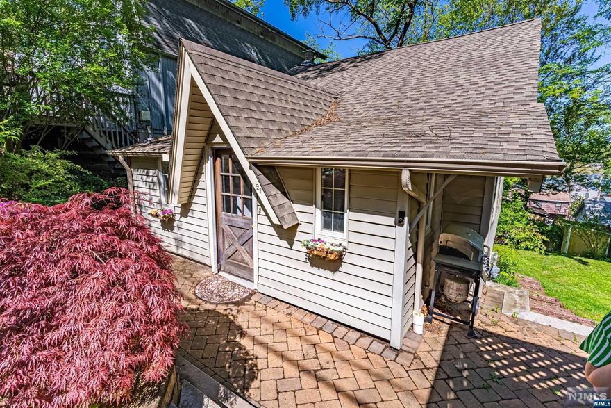 NEW PRICE TAG for this Condo Alternative. WHY RENT when you can PURCHASE this Cozy Cottage with Lake Views? Tons of potential w/ranch style living situated in the desirable Indian Lake community just minutes from beach sunbathing, swimming, boating & more. Tons of Versatile Living Space! Painted inside & out! 1st floor great living space! 3 bedrooms & bath w/tub shower! Woodburning stone fireplace stands proudly in the oversized living/dining area. Galley kitchen & large pantry conveniently located off paver patio for BBQs, relaxation & entertaining. Full, walk-out BSMT w/family room, office & laundry. New insulation, drywall, flooring and new windows. Plenty of storage in basement & attic! The yard provides privacy & Indian lake views. Exclusive driveway for 2! Just mins to Downtown Denville -a vibrant town w/shopping, farmers markets, restaurants, NYC bus/train & lovely music that plays while you stroll down Broadway, music venues in the park & art shows! Top rated schools!