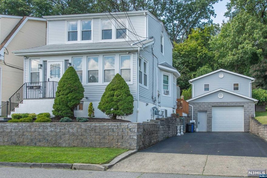 Unique and private multi level two family home on desirable quiet street offering magnificent views and charming front porch while located in close in proximity to public transportation and shopping. First and second floor units both offer updated eat-in kitchens w/granite counters, SS appliances, large formal living rooms, spacious bedrooms w/built in modern closet systems in one, newer bathrooms, walk out to private decks completes the first and second levels. Basement/ground level offers a spacious family room, additional space for a small office area, full bathroom, storage, laundry area w/separate entrance. True bonus feature: hands down the coolest thing ever; a leisure room / Human Cave w/wood burning stove, bar and lounge area designed for the ones who wish to unwind from a long days' work, or simply turn into a private large office, conveniently located above the garage, just steps away from the house. Garage has high ceilings, great for cars or gym. Separate utilities.