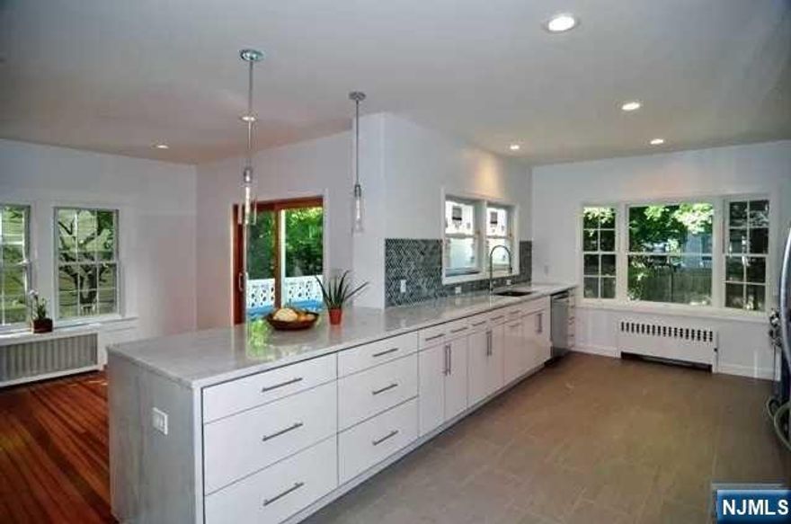 Step inside this stunning open-concept residence where modern upgrades meet timeless comfort. At the heart of the home is a beautifully updated kitchen featuring sleek stainless steel appliances, a striking quartzite island, and seamless flow into the open dining room. From here, sliding glass doors lead to a spacious deck and a private backyard, an ideal retreat for summer gatherings, outdoor dining, or simply enjoying the fresh air. Natural light floods every corner of the home, highlighting its warm and inviting character. The cozy family room, anchored by a charming wood-burning fireplace, offers the perfect place to unwind at the end of the day. An additional half bath on the main floor. Upstairs, discover four generously sized bedrooms and 2 full bathrooms. The highlight is the serene primary suite, complete with a private bathroom and a walk-in closet with a window for natural light. Perfectly located, this home is close to NYC transportation, top-rated Tenafly schools, beautiful parks, and all the conveniences of town living. A rare rental opportunity in one of Bergen Countyâ€™s most sought-after communities!