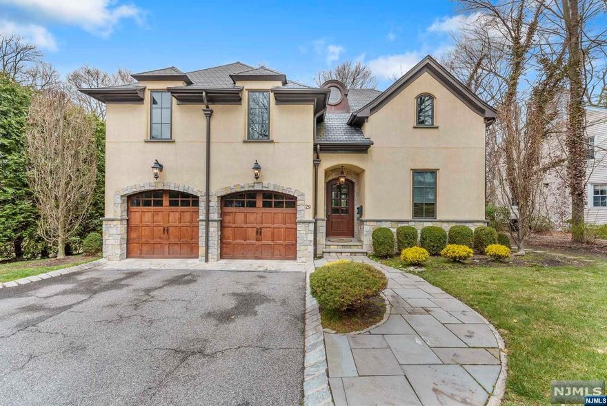 Timeless signature french chateau crafted in 2011 by a Renowned Local Master Builder. This exquisite East Hill estate on a cul-de-sac features approx. 4500 sq ft of luxurious living w/highest quality and finishes. Stone & Stucco exterior, Brazilian Walnut hardwood floors throughout, beamed ceilings in dining room & bedrooms, custom moldings, trim, & marble throughout. A custom gourmet Kitchen with high end Subzero/Wolfe, Miele appliances opens to a over-sized Family RM that includes surround sound & wood burning F/P. Also opens to the bluestone patio deck with barbecue. The first floor includes an Office with dual sided gas F/P that opens on the other side to the LR with a dry bar. The second floor offers a Master suite w/ trey ceiling & Juliet balcony, walk-in closet, & radiant heated bathroom. 2 add'l bedroom en-suites & a laundry room. The lower level features a media rm/ a bedroom, a Rec rm, a Gym & a full bath and, a walkout to a covered outdoor living area. Tenafly's Finest.
