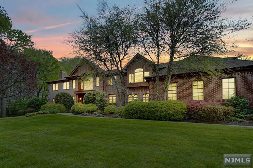 **TAXES UNDER APPEAL.** Rare opportunity to live on one of Tenafly's most desirable East Hill cul-de-sacs. This elegant 15-room brick colonial is located on a private acre surrounded by mature trees for added privacy. Approx. 6000 sq. ft. of luxurious living space (not incl. LL & garage) with stunning 2-story entry thru each of the large, gracious rooms--perfect for living & entertaining in style: LR w/fireplace, formal DR; home office, generous Kitchen opening to a spectacular Family RM w/granite fireplace & custom Madagascar ebony built-ins. This level also incl. an ensuite BR and large PR. The 2nd level features 5 large BRs, incl. Primary Suite w/fireplace & ensuite, 2 add'l ensuite BRs, 2 large BRs & full BA. Luxury living continues on the finished LL w/Wine Cellar, Media RM, Rec RM, Gym, full BA & more. Backyard oasis boasts a newly resurfaced Pool w/waterfall & spa. Second stairwell off mudroom; 3-car garage; gated oversized driveway; generator.