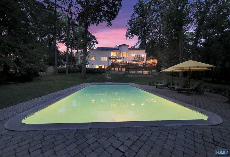 Picture yourself in this home set on a private 1-acre property on Tenafly's prestigious east hill area with top rated schools, a 20x40 heated pool, the amazing outdoor living offers a Brazilian IPE Wood 2 tier deck w/built in kitchen, heavy duty BBQ, refrigerator, a Gazebo w/fire pit... The Soaring ceilings & ceiling high windows create a dramatic first impression the moment you enter. A custom-built loggia consists of 4 bdr of which 1 en-suite bedroom 3 additional large bdr, 1 fbth. Separate a stunning large master suite with a fireplace, a seating area a spa grade master bath and a balcony overlooking the private Shangri-La. This house has been expanded, rebuilt and renovated in the early 2000's & 2010's walk out family room adjacent to en-suite maids bedroom, finished basement, 2 FPL Wood & electric, a gourmet kitchen, Surround System, top appliances, a wine closet, an electric car charger and more, taxes less than $50k