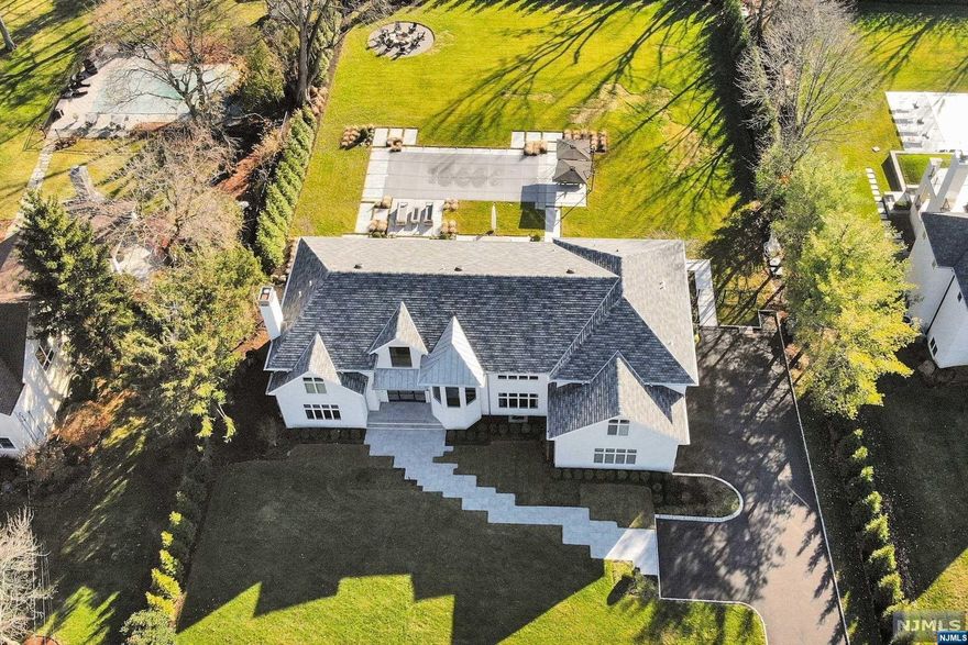 SUPER RENOVATED EASTHILL CENTER HALL COLONIAL: Recently renovated under the direction of renowned designer, P. SMITH DESIGN, virtually all facets of 128 Kent Rd have been exquisitely remodeled. Featuring 7 BRs, 6.5 baths over 15 RMs on a truly level 1 acre lot [APRX]--128 Kent Road is an extraordinary offering in the Tenafly luxury home market. With over 6100 SF above ground (per tax record) of exceptionally finished space, & nearly 2700SF finished basement, this truly light filled home (southern exposure) provides the appointments & space for modern living. Receive guests in the 2 story entrance hall, prepare meals in the spacious gourmet contemporary kitchen, entertain in the beautifully designed open floor plan, 5 star spa-like pool & outdoor kitchen, & park-like property--and then retire to your uncompromising luxe MSTR suite. Gym, movie theater, 3 garages, 1st Flr guest Rm, Tenafly Schools, minutes from NYC, and much more--make it yours!