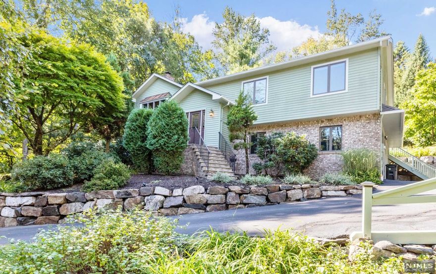 Opportunity knocks to live in one of the most desirable neighborhoods in town. Custom wood work throughout.Cathedral cedar ceiling.Wood floors.Roof 2019. Central air.Anderson casement windows.New gutters & guards & more!Top rated schools.Over 2,400 sq ft of living,privately set w/lush manicured grounds. Double cul-de-sac neighborhood.Striking open floor plan.First level offers gorgeous kitchen w/custom maple cabinets,palladium window,speaker system, and sliding glass door to patio overlooking beautiful grounds w/water feature & fire pit.Living room open to dining room.Master bedroom suite w/trey ceiling,large picture window w/stunning garden view, walk-in closet & master bath.Two additional bedrooms,both having large closets and main full bath w/jetted tub.Lower walk-out level is complete w/family room with gas fireplace,bedroom,full bath & laundry room.Multi-zone baseboard natural gas heating.200 AMP electrical service.Over-size two car garage.Convenient to town center & schools.