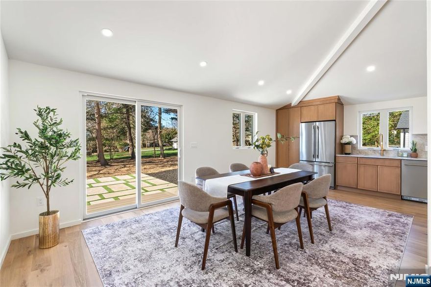 Welcome to 175 E Crescent Ave, an exceptional, fully reimagined residence offering approximately 3,200 SF where design, scale, and craftsmanship come together seamlessly. Featuring 5 bedrooms and 3 full baths, this home has been thoughtfully curated with high-end finishes and a layout that delivers both presence and practicality. The main living level is defined by a seamless flow between the kitchen, dining, and living areas, creating an expansive, light-filled environment designed for both everyday living and elevated entertaining. The kitchen is outfitted with premium materials, a center island, and modern appliances, all anchored by rich hardwood flooring. A wood-burning fireplace adds a refined focal point to the living space. The home offers a flexible layout, including a ground-level bedroom and full bath with a separate entrance, ideal for a variety of uses. Upstairs, the primary suite is complemented by additional bedrooms, baths, and a conveniently located laundry area. A finished walkout basement adds functional living space, while the outdoor setting, featuring a deck, patio, and yard, extends the home's livability. Additional features include central air, multi-zone heating, and a detached 3-car garage with ample driveway parking. A rare opportunity to own a home of this caliber, where quality, layout, and finish set it apart.