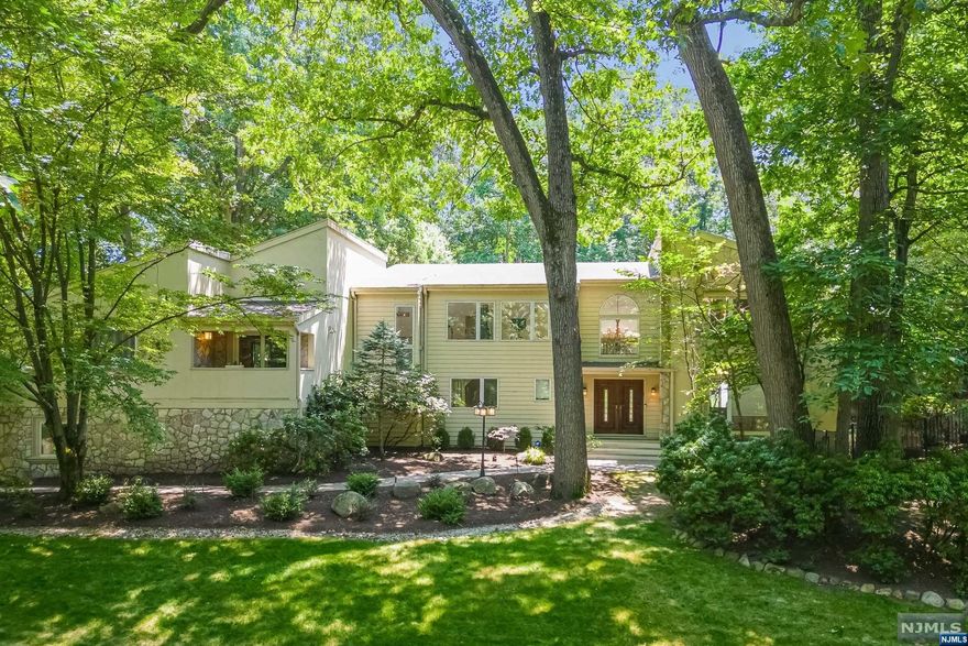 Welcome to this magnificent Contemporary home nestled in a tranquil cul-de-sac, showcasing breathtaking vistas of Lake Tappan. A grand 2 story foyer invites you into an open floor plan revealing a dramatic layout adorned with 10-foot ceilings. A dining room & living room provide the perfect setting for entertainment. The gourmet kitchen features stainless steel app, refrigerator and freezer, an island flowing effortlessly into the family room with its vaulted ceiling, gas fireplace, wet bar. Step outside to discover a private backyard oasis, complete with patio, lagoon pool & tranquil waterfall feature. A mudroom with 3 car garage access & main floor guest suite & full bath. The upper level features a luxurious primary suite with a sitting area, terrace,2 WIC & a primary bath/w a large glass shower. Loft/w picturesque views is home to a gym, 2 bedrooms & full bath. Lower level offers a rec/game room, office, bedroom, & full bath. Close to Blue Ribbon Schools & NYC transport.