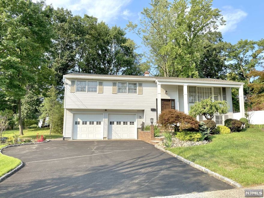 Full of sun, bright and spacious, living from ,dining room, kitchen has open layout to gorgeous family room with high ceilings and heated floors and sliding door to double layered deck. Master bedroom with a full bathroom and two large closets. Ground floor has one large bedroom and one full bath (could be used as in law suite ) laundry area and entrance to garage.Large windows. new roof , new water heater, new French drain on the exterior of the house, 2 zone Central air, 2 zone heating (Family room has its own thermostat) enjoy nature from extra large deck. 2 Car garage.