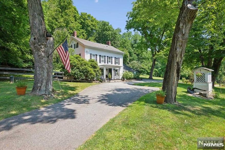 Renovated 1875 Colonial is an exquisite blend of old-world charm & modern luxury. Nestled on 3+ acres of meticulously kept property, this home boasts vintage details blended w/contemporary conveniences & is near charming Chester town, shops, dining, top schools & more. Offering 3 levels of living space, gracious formal dining room w/refinished pumpkin pine floors, brick, eat-in kitchen w/wood cabinetry, quartz countertops & SS appliances. The "back kitchen" has more cabinetry, soapstone countertops & adjoining laundry room. A bright & airy Great Rm complete w/fireplace, beamed vaulted ceiling, hardwood flr offering a cozy atmosphere. The 2nd floor hosts 3 sizable beds, full bath & foyer leading to the 3rd fl private primary suite w/vaulted ceilings, hardwood flr, exposed brick, reading nook & luxurious ensuite w/oversized shower. A secluded backyard oasis invites you to swim in the salt-water in-ground pool, sit by the firepit, dine on the side patio or relax in the lovely gardens