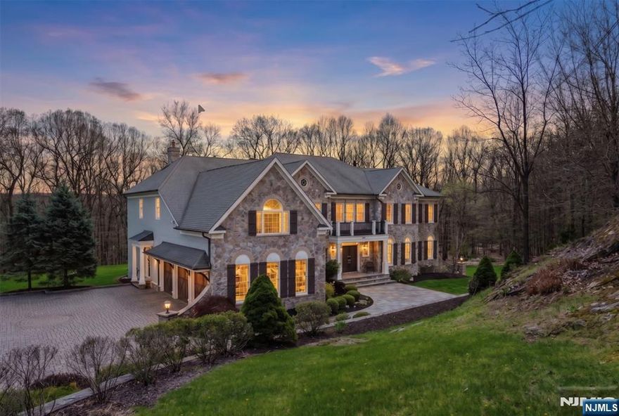 Step into timeless elegance and modern comfort in this stunning colonial set on a beautifully landscaped 1.7-acre property. A grand butterfly staircase and soaring ceilings welcome you into a bright, open layout designed for both entertaining and everyday living. Refined details include coffered ceilings, custom millwork, bespoke architectural detailing, crown molding, expansive room sizes, and abundant natural light throughout. Impeccably finished to the highest standard with luxury-grade materials, this home offers 5 spacious bedrooms, including a flexible guest suite or playroom, 5 full baths, and a powder room for exceptional versatility. The gourmet kitchen features granite countertops, custom cabinetry, a center island, double ovens, and a wine coolerâ€”ideal for gatherings large or small. Enjoy cozy evenings by one of two fireplaces or unwind in the sunlit conservatory and solarium. A full unfinished walk-out basement with French doors to the patio offers endless potential for recreation, fitness, or additional living space. The exterior showcases premium stone construction (no vinyl siding), a high-end stone/paver driveway, and wooden garage doors. Outdoor living shines with a stone patio and fire feature, two new modern decks, a backyard play area, and newly replaced windows. Located in sought-after Sparta, enjoy a luxury lifestyle with golf, boating, dining, and year-round recreationâ€”just 60 minutes to NYC. ALL Furniture available for purchase.