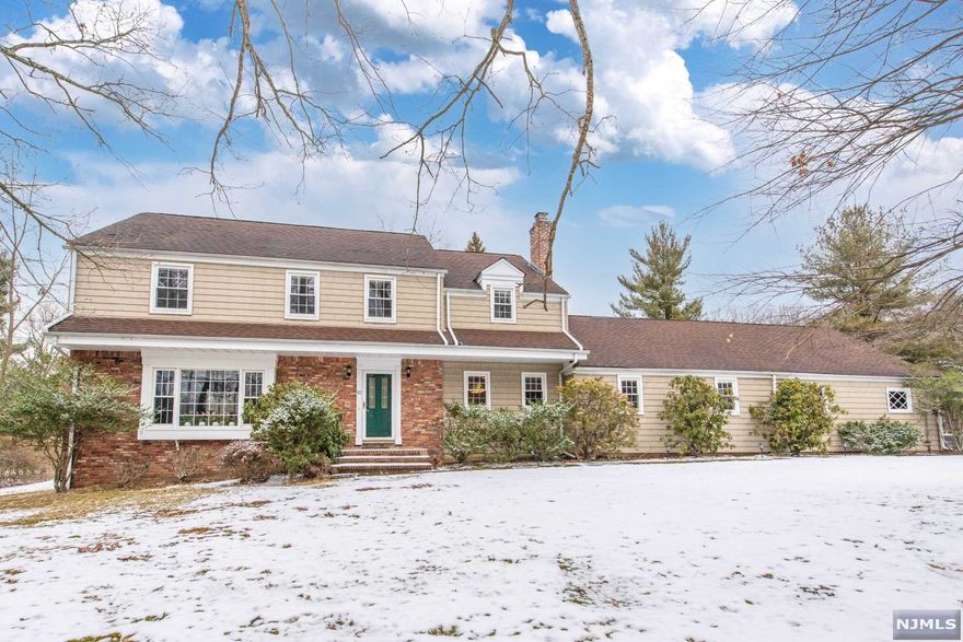 Breathtaking views from this sprawling colonial overlooking Crestmont Country Club!Nestled on over a half acre lot,the expansive open floor plan is perfect for year round entertaining!Remote office possibilities on each floor with hardwood floors throughout & pocket doors as well.All white kitchen features subzero refrigerator plus wet bar & corian countertops, & opens to delightful sunroom with sliders,making it accessible to deck & yard.Marble in master bath with double sinks & jetted tub.Multiple access points from within house to exterior.Charming living room with bay window has sunken access from dining room,which features bow window as well.Large family room & great room with cathedral ceilings.Dramatic floor to ceiling fireplace allows for viewing from both billiards area & great room.Custom built cherry bookshelves & entertainment center along with custom cherry wet bar with granite countertops will wow your guests.A stone's throw to NYC trans.AHS 1 year warranty incl.