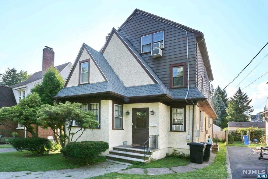 Welcome to this gracious Colonial Tudor home featuring an entry foyer w/ coat closet, spacious living room w/ a wood-burning fireplace, formal dining room, den and a large-sized eat-in-kitchen. Second story includes 4 sizable bedrooms and 1.5 bathrooms. The third level features the primary suite w/ a huge sitting area/office and private bathroom ensuite. Finished basement has a recreation room, separate laundry room w/ half bathroom, utility room and access to the attached, 1 car garage. The house has a Walk Score of 72 out of 100 - only minutes away from houses of worship, transportation to NYC, shopping and restaurants. Close to schools, parks and recreation and major highways. This is a whole lot of house not to be missed!