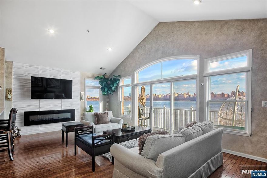 Bulls Ferry Fulton style home for sale!! North east corner unit with magnificent panoramic NYC and Hudson River views!!! Lots of windows throughout home. Flooded with light all day long!! Private elevator. Soaring ceilings. Wall of windows and slider to 24 foot view balcony. Hardwood floors. 42 inch white cabinets, quartz countertops/back splash and black stainless steel appliances in gourmet kitchen. Custom painted. Skylight over jacuzzi tub in sumptuous renovated master bathroom. Newer HVAC system. Parking for two cars; one in private garage; one in driveway. Community boasts two pools with jacuzzis, tot lot, waterfront promenade and park, and free shuttle to ferry. Steps to 158 bus to NYC. Close to restaurants and shopping. The Epitome of Waterfront Living!!!!