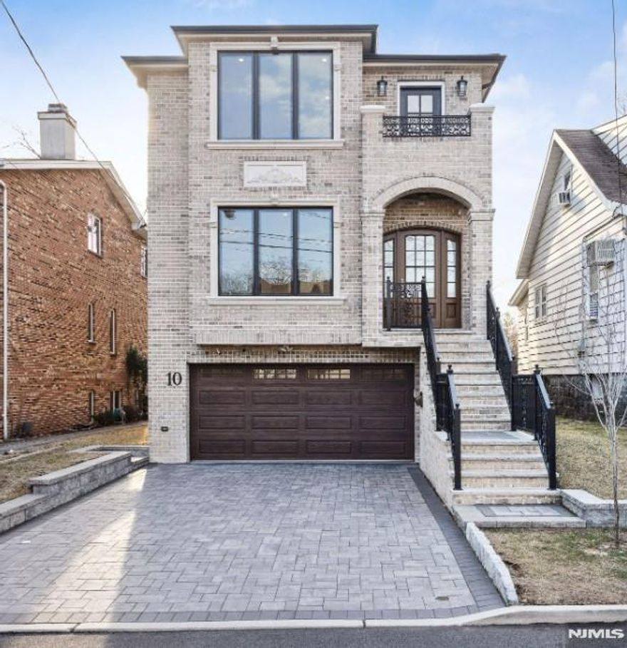 This stunning 2022 custom built property boasts approximately 3,600 square feet of luxurious living space, featuring 4 bedrooms and 3.5 elegantly appointed bathrooms. Nestled in a quiet residential street in EC, this residence offers modern amenities and timelessness. Entry foyer opens into living room, formal dining room, gourmet kitchen with center island and sun-drenched family room with fireplace and deck. Primary bedroom with tray ceiling, his and her walk-in closets, and en-suite spa like bath with oversized shower. Two additional bedrooms upstairs with shared bathroom. Ground level with additional bedroom and full bath, 2 car garage, recreation room and sliding glass with access to backyard. Multi zone cooling and heating with radiant heat in kitchen, family room, and primary bath. This home is conveniently located close to local shops, parks and public transportation to NYC. DONâ€™T MISS THIS RARE OPPORTUNITY 2022 CUSTOM BUILT HOME WITH LOW TAXES AND THE BEST OF BERGEN COUNTY!