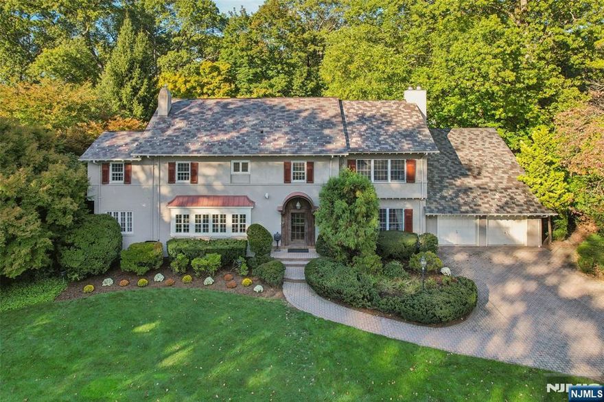 Welcome to the Heart of Heights! Prepare to be captivated by this approx. 6,000 SF Center Hall Colonial, set on one of the most beautiful streets in town on 0.57 acres of lush grounds. Sophistication and beautiful old-world Ridgewood character are evident upon entering the residence - much of which was part of a late 1980s addition/renovation - featuring 6 bedrooms, 5 full & 2 half baths, 9-10 ft ceilings, hardwood floors, and detailed moldings throughout. The entry foyer leads to a family room with oversized windows, built-ins, a fireplace, and a seamless flow into the kitchen, with a semi-vaulted ceiling, large eat-in area, skylights, and a butler pantry. A formal dining room, living room with a fireplace, sunroom/covered porch, and bedroom suite with its own entrance from the attached 2-car garage wrap up the 1st floor. On the 2nd level, the expansive primary bedroom offers 3 walk-in closets, fireplace, office, and spa-bath with a steam shower & jetted tub. Three more sizable bedrooms, and a 3rd floor with a full bath and flexible bedroom/office complete the upstairs. A partially finished basement offers 9 ft ceilings and opportunity for extra finished space. The private, level, and fenced backyard w/ manicured landscaping, has a patio for entertaining and a 2nd garage that is multifunctional. Slate roof new in the early 2000s, new HVAC 15 years ago, whole house incredibly maintained. An exceptional home ideally located blocks from downtown, the train, Ridge ES, and GWMS!
