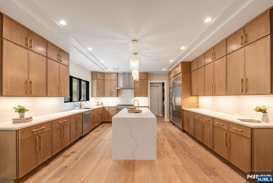 Welcome to this stunning new construction 5-bedroom, 5.5-bath Colonial, ideally located in the heart of a beautiful tree-lined neighborhood. Thoughtfully designed with timeless style and todayâ€™s must-have amenities, this home offers an exceptional layout for both everyday living and effortless entertaining. The main level features a showstopping kitchen with an oversized island, walk-in pantry, two sinks, double ovens, and abundant custom cabinetry. Just beyond, the sun-filled great room is anchored by a gas fireplace and opens seamlessly to the composite deck and backyard. Also on the first floor: formal dining and living rooms, a private office, a chic powder room, and a first-floor en-suite bedroom. Upstairs, every bedroom includes its own en-suite bath, including a luxurious primary suite with tray ceiling, spa-like bath, and oversized walk-in closet. Fine craftsmanship shines with custom moldings, wide-plank hardwood floors, and designer finishes. Additional highlights include energy-efficient hydronic heating and a finished basement with soaring 12-foot ceilings. Enjoy the inviting front porch, spacious backyard, and close proximity to Haworthâ€™s charming downtown, top-rated schools, parks, and NYC transportation.