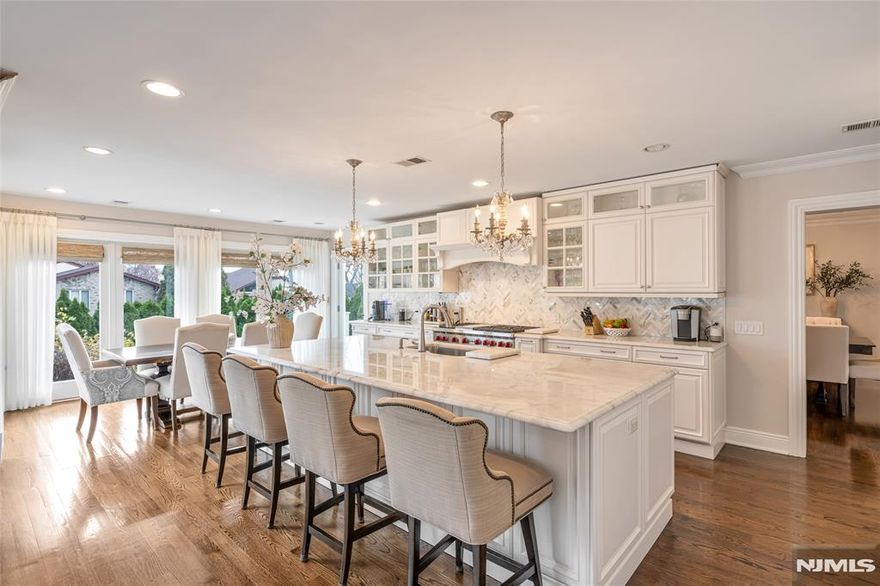 Welcome to this Premier East Side Colonial on an oversized property. This striking brick and stucco home is designed for grand entertaining, modern living and beautiful finishes throughout. A dramatic foyer opens to a formal living w/ gas fireplace, formal dining room, powder room, and a gourmet kitchen featuring an oversized island, Sub-Zero refrigerator, Wolf range w/ grill, Wolf microwave, custom cabinetry & designer stone surfaces. A spacious family room and full en-suite bedroom complete the 1st floor. Interiors showcase Calacatta, Danby & Asian Statuary marble, rich hardwood floors, porcelain-tiled baths, high ceilings. The 2nd level boasts high ceilings and a luxurious primary suite w/ spa-like bath, his & hers custom walk-in-closets and private terrace capturing stunning NYC skyline views. Two addâ€™l bedrooms share a beautifully designed Jack-&-Jill bath. The fully finished lower level offers a rec lounge, custom wet bar, full bath, walk-in cedar closet and bonus room ideal for wine cellar, cigar room, gym or office. Outdoor living is thoughtfully designed with two terraces, a rear paver patio, and dedicated seating areas for entertaining. Yard, garage & patio are privately set at the rear on a peaceful dead-end street. Additional Features ,custom molding, 2-car heated garage w/ epoxy flrs, central air and heat, sprinkler, alarm, slate entrance, pavers throughout, & addition completed approximately 10 yrs ago. Rare opportunity in prime Cliffside Park location.