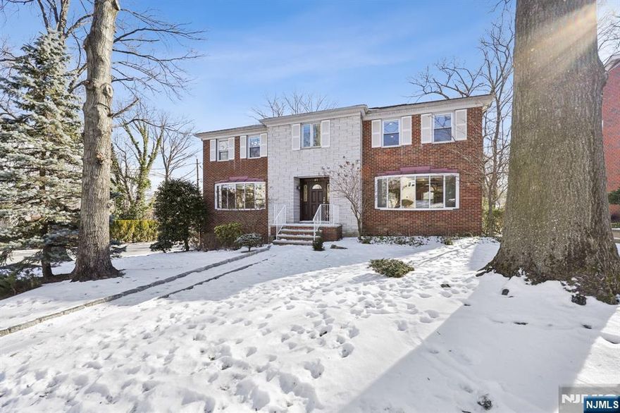This exquisite, well-maintained Center Hall Colonial is located in prestigious Englewood Cliffs. The main level features a grand entry foyer, a huge living room with a wood-burning fireplace, an oversized dining room, a bright and airy family room with skylights, and a spacious eat-in kitchen with ample cabinet space. The kitchen opens to a large back deck where a natural gas grill is conveniently integrated. The deck overlooks a sprawling backyard, ideal for entertaining or relaxing. The second floor is dedicated to bedrooms and has a sweeping primary bedroom suite with a large walk-in closet. The Primary bedroom bath features a steam shower and jacuzzi tub. Three more spacious bedrooms and a full bath complete this level. The fully finished basement offers an office or fifth bedroom, a full bath, an open area perfect for a recreation room, a laundry room, and access to both the two-car garage and the backyard. This house is equipped with a backup generator, central air conditioning, and baseboard heating for your year-round comfort. Located near public transportation for convenient travel to Manhattan, and it's in close proximity to schools and places of worship.