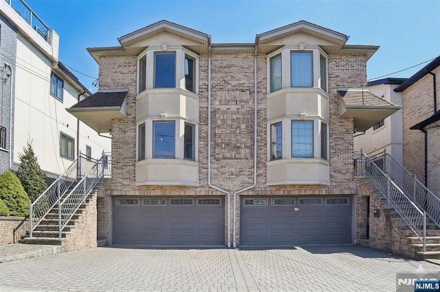 Spacious 4BR/3.5BA duplex in a quiet Palisades Park neighborhood. Bright, open-concept living room with hardwood floors, wood-burning fireplace, and bay windows. Updated eat-in kitchen features granite countertops, center island, stainless steel appliances, and sliding door to a private deck. Nine-foot ceilings throughout. Marble bathrooms. Attached garage. Minutes to GWB and NYC bus lines.